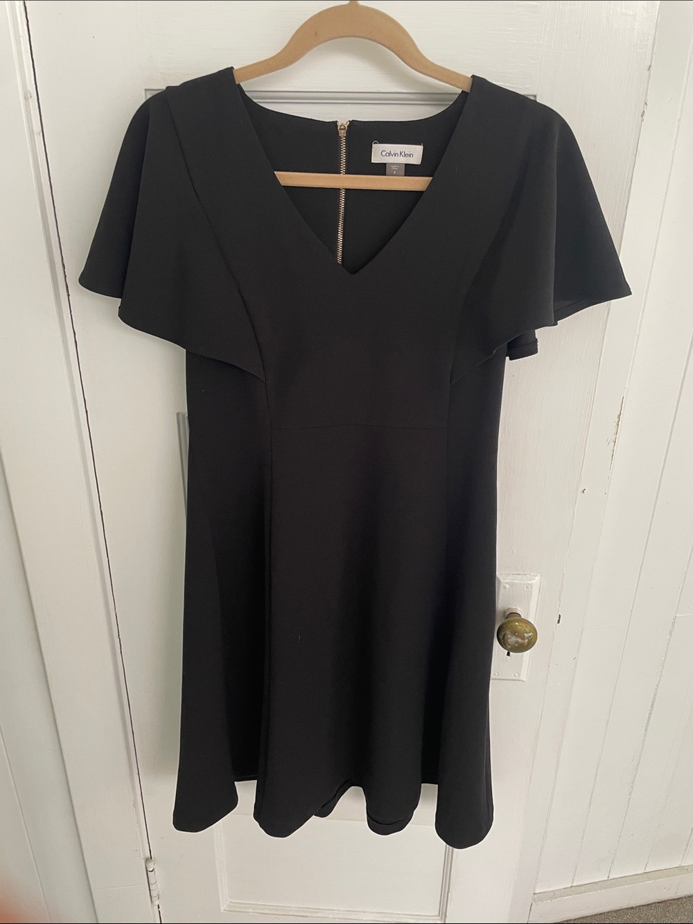 Calvin Klein size 8 black A-line dress with flutter cap sleeves, gold zipper